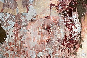 Tatter of a multi-colored old paint on a surface of a stone wall photo