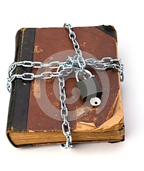 Tattered book with chain and padlock