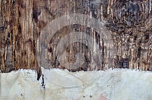 A tattered rag on an old textured wood surface