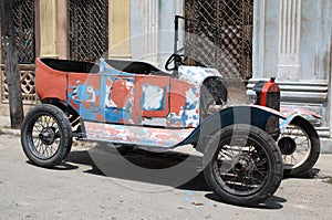 Tattered vintage car in a street of Havana, Cuba