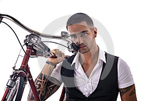 Tattoed elegant man holding his bicycle