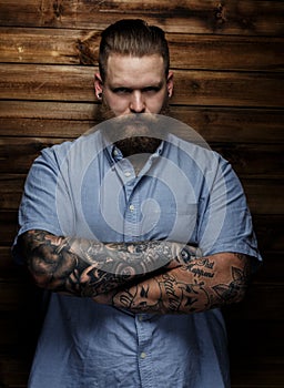Tattoed man in blue shirt.