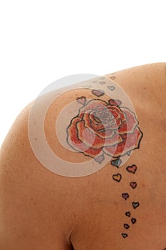 Tattoo close rose on shoulder