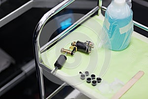 Tattoo ink and gun on table