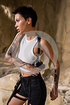 tattooed archaeologist with short hair taking