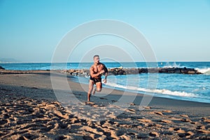 Tattooed bodybuilder sexy male coach at the beach.