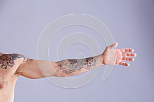 Tattooed man on grey background