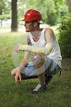 Tattooed man in plaster
