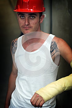 Tattooed man in plaster