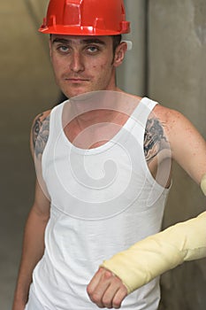 Tattooed man in plaster