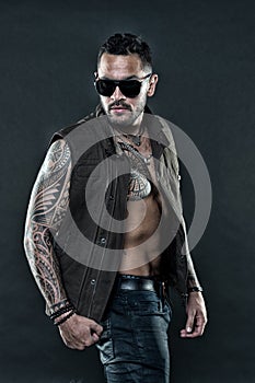 Tattooed man with six pack and ab. Bearded man with tattoo on chest and arms. Tattoo model with beard on unshaven face