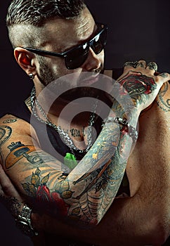Tattooed man in sunglasses