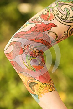 Tattooed woman's arm.