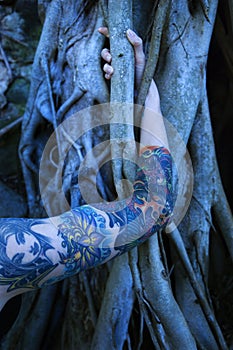 Tattooed woman's arm.