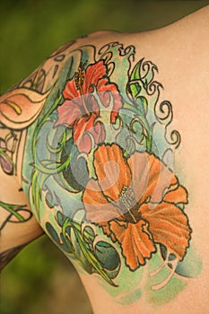 Tattooed woman's shoulder.