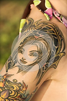 Tattooed woman's shoulder.