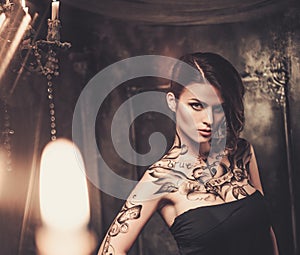 Tattooed woman in spooky interior