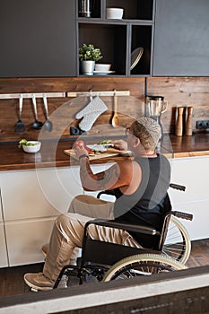 Tattooed Woman in Wheelchair Cooking