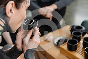 tattooed young man smelling puer tea