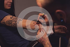 Tattooer makes scetch photo