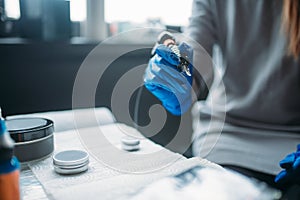 Tattooist holds tattoo machine in hand, tattooer photo