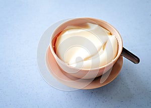 Tau foo fah (Soy bean pudding) in a bowl on top of a table