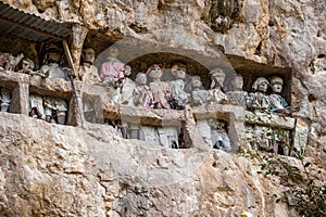 Tau tau, wooden statues representing dead men at burial cave, Tana Toraja, South Sulawesi, Indonesia