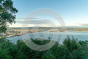Tauranga harbour and the port wharves with distant hills photo