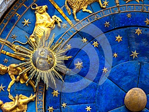 Taurus astrological sign on ancient clock. Detail of Zodiac wheel with Sun and Taurus photo