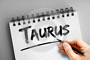 Taurus text on notepad, concept background