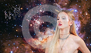 Taurus Zodiac Sign. Astrology and horoscope. Beautiful woman Taurus on the galaxy background