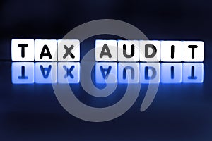 Tax Audit Spelled Out in Block Words Representing IRS Audit Stressful Taxes