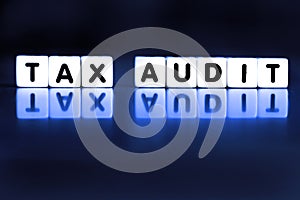 Tax Audit Spelled Out in Block Words Representing IRS Audit Stressful Taxes photo