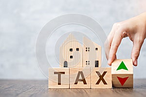 TAX block with house model. real estate, Home loan, taxation, payment and financial concept