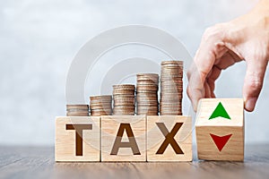 TAX block with UP and Down arrow symbol on table. Financial, tax deduction, taxation planning, Management, business and Economic