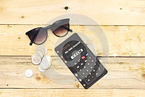 Tax on calculator concept. algeria coins and sunglasses