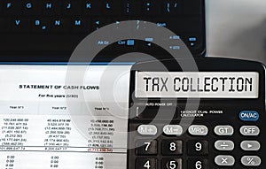 Tax collection - concept of text on calculator display. Top view