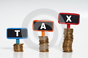 Tax Concept with tax word on stacked gold coins