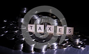 Tax concept.wooden blocks with taxes word on coins