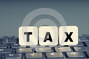 Tax Concept with tax word on keyboard, online submission photo