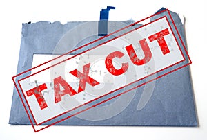 Tax cut concept, text design `Tax cut`  blue envelope of tax form as the background.