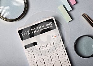 Tax deadline inscription on white calculator on ofice desk