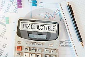 TAX DEDUCTIBLE word on calculator. Business concept