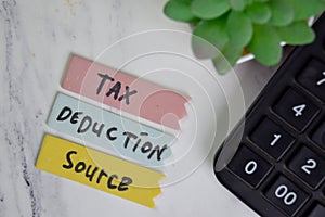 Tax Deduction Source write on sticky notes isolated on Wooden Table