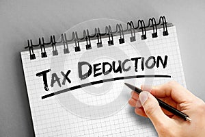 Tax deduction text on notepad, concept background