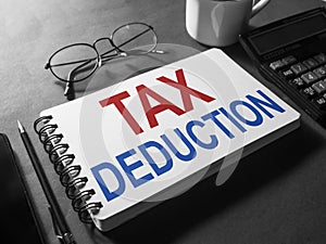 Tax deduction, text words typography written on paper, life and business motivational inspiration