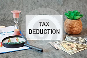 TAX DEDUCTION is written in a document on the office desk, money and diagram