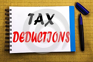 Tax Deductions. Business concept for Finance Incoming Tax Money Deduction Written on notepad note paper background with space offi