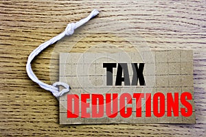 Tax Deductions. Business concept for online saleFinance Incoming Tax Money Deduction written on price tag paper with copy space on
