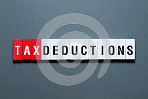 Tax deductions - word concept on building blocks, text